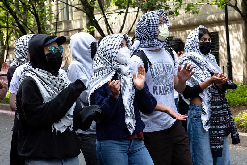Pro-Palestinian protesters chant near an entrance to Columbia University (Michael M Santiago/AP)