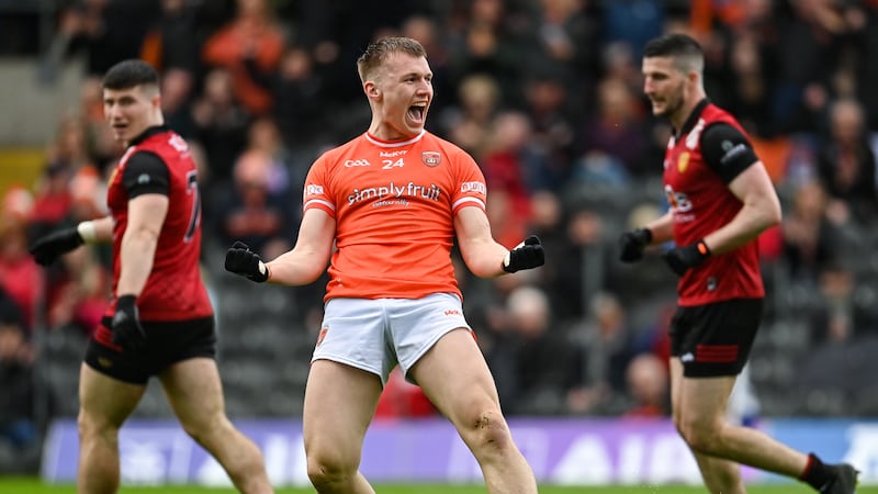Daniel Guinness looks on enviously as Rian O'Neill of Armagh celebrates after scoring his side's fourth goal last year. Photo by Ramsey Cardy/Sportsfile