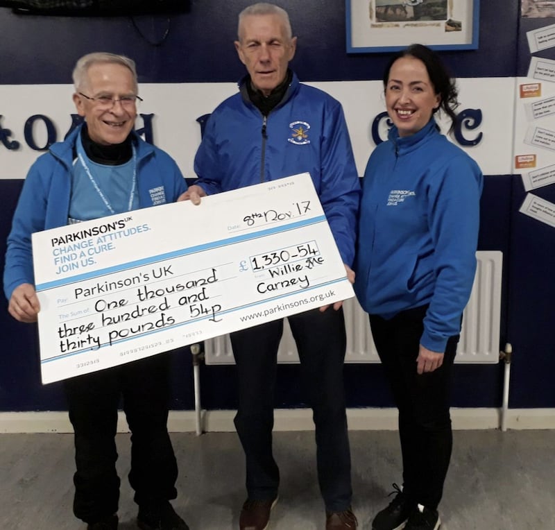 Willie McCarney and St John&rsquo;s, Belfast chairman Gerry McCann with a cheque for &pound;1,330.54, which will be given to Parkinson&rsquo;s UK. Seventy-nine-year-old Willie, who has Parkinson&rsquo;s, took part in &lsquo;Run October&rsquo; to raise funds for this charity. He aimed to do one marathon but ended up doing three by running one mile every day and three miles on Saturdays and Sundays. St John&rsquo;s heard of his endeavours and weighed in with &pound;480 raised through the sale of club flags for the Antrim championship final in October 