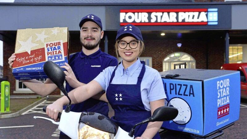 Four Star Pizza team members Brendan Morris and Shannon O&rsquo;Rawe celebrate the opening of the new Lisburn store 