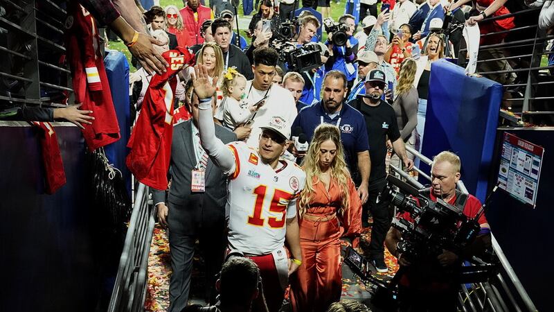 Kansas City Chiefs quarterback Patrick Mahomes (15) leaves the field with his wife, Brittany Mahomes, after winning NFL Super Bowl 57 against the Philadelphia Eagles.