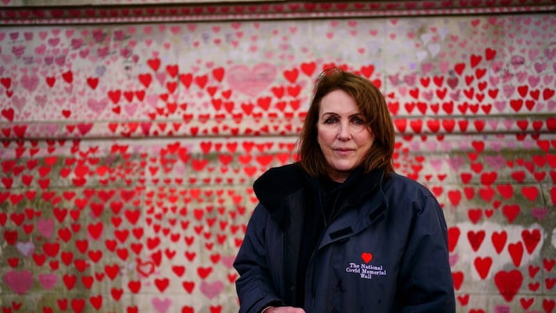 Fran Hall, whose husband served in the police for more than three decades before dying with coronavirus, and who is spokesperson for the Covid-19 Bereaved Families For Justice campaign group, standing by the National Covid Memorial Wall opposite the Palace of Westminster (Victoria Jones/PA)