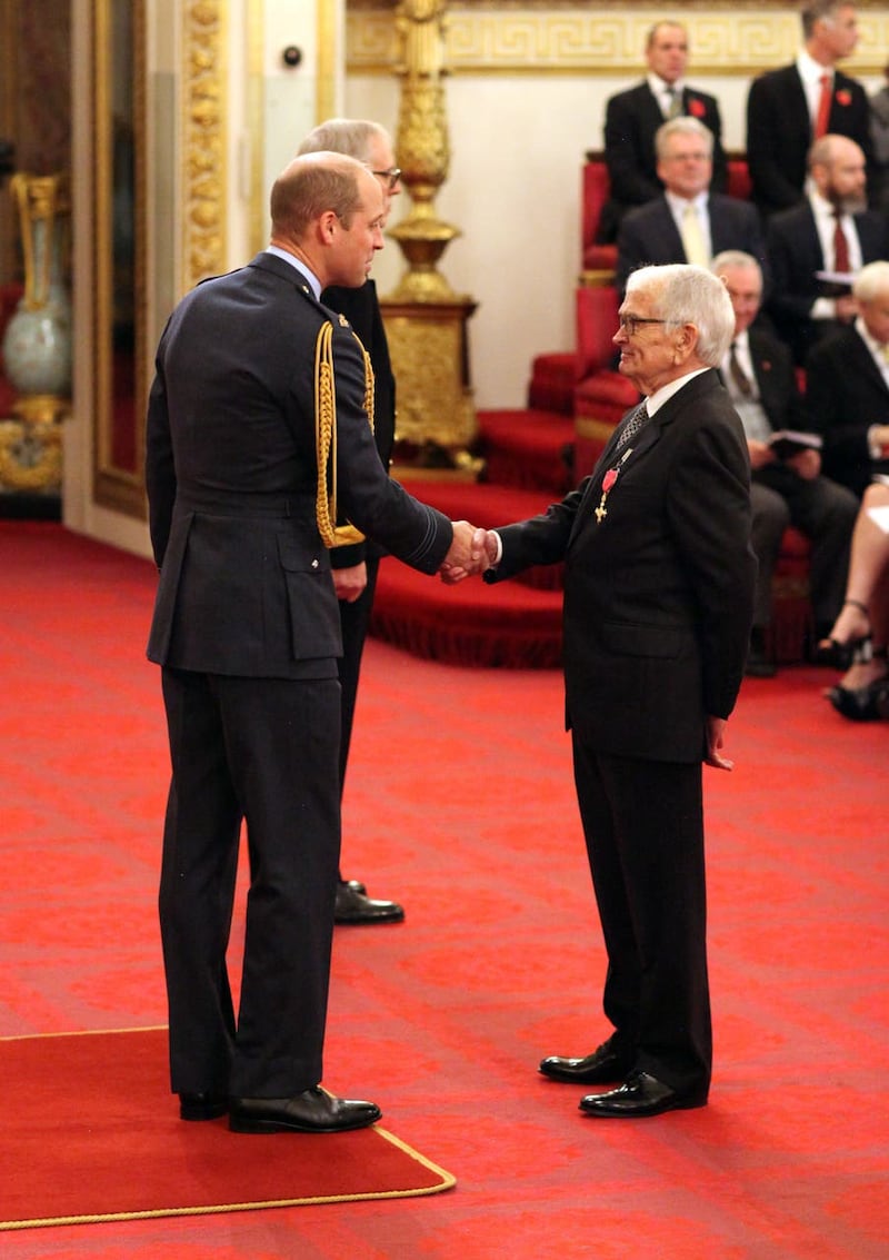 Mr Cosgrove receives his honours from the Duke of Cambridge, who told him he is a fan of his work (Jonathan Brady/PA)