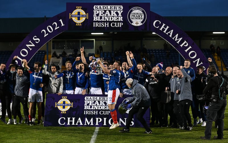 Linfield players and officials celebrate after victory over Larne in the Sadler's Peaky Blinder Irish Cup final at Mourneview Park in Lurgan on Friday May 21 2021.<br />Pic Colm Lenaghan/Pacemaker