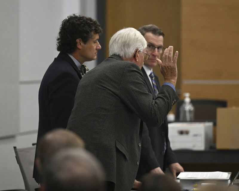 Thomas Martens, center, stands with attorneys Jones Byrd, left, and Jay Vannoy as he swears on a Bible, pleading guilty to voluntary manslaughter during a hearing, Monday, Oct. 30, 2023, for Martens and his daughter, Molly Corbett, in the 2015 death of Molly's husband, Jason Corbett at the Davidson County Courthouse in Lexington, N.C. Picture by The Winston-Salem Journal, AP