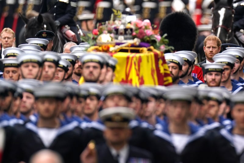 The Duke of Sussex follows the State Gun Carriage as it carries the coffin of Queen Elizabeth II, draped in the Royal Standard with the Imperial State Crown and the Sovereign's orb and sceptre, in the Ceremonial Procession during her State Funeral at Westminster Abbey