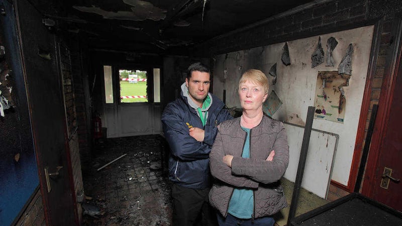 Ryan O&#39;Neill, player, and Mary Daly, secretary, examine the damage to the GAA club in Moy which was burned over the weekend Picture by Cliff Donaldson 