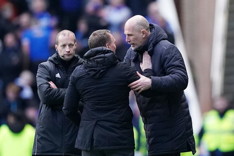 Clement and Rodgers embrace at Ibrox