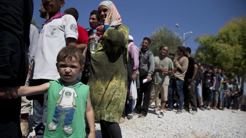 Refugees wait to receive food at Lesbos island in Greece  