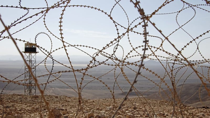 A barbed wire fence and an Egyptian guard tower on the Sinai peninsula 