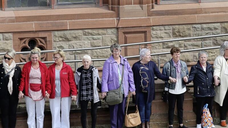 Women held hands during a minute&#39;s silence at Derry&#39;s Guildhall Square organised to commemorate murdered journalist, Lyra McKee. Picture by Margaret McLaughlin 