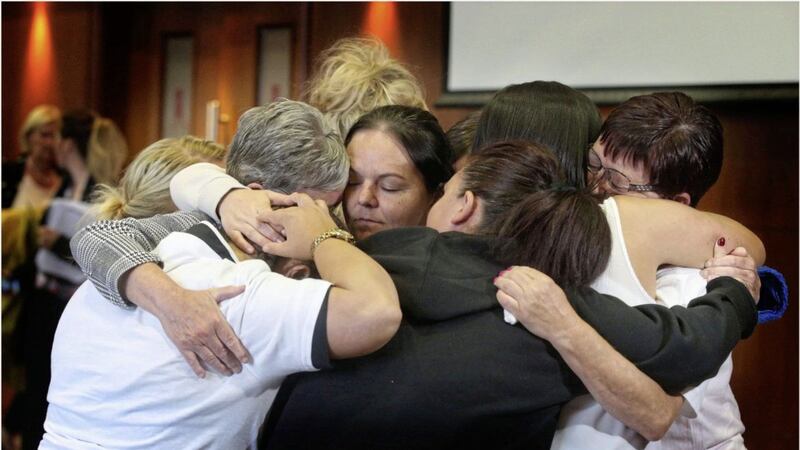 &nbsp;Family members seek comfort in a hug after the release of a damning report into Dunmurry Manor Care Home. Picture by Hugh Russell