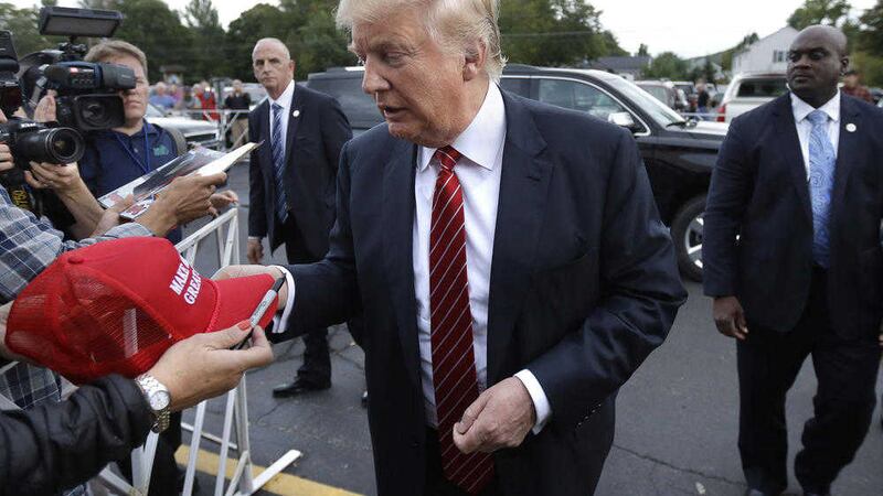 Republican presidential candidate, businessman Donald Trump signs autographs as he arrives at a campaign stop, Wednesday, Sept. 30, 2015, in Keene, N.H. (AP Photo/Steven Senne) 