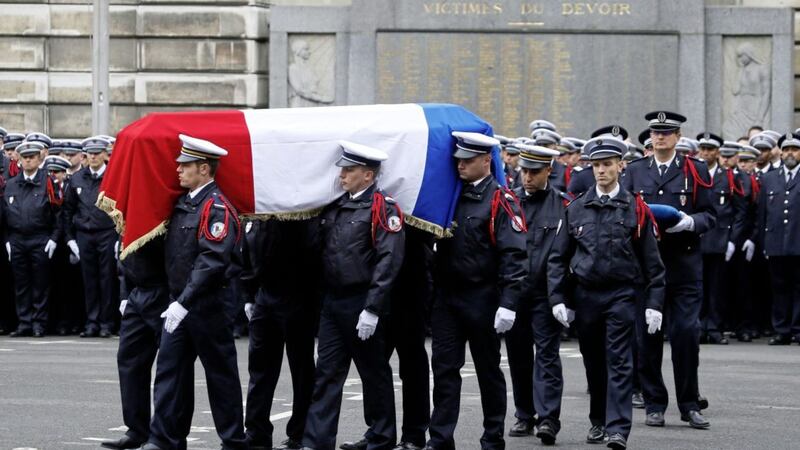 The coffin of slain police officer Xavier Jugele is carried in the courtyard of the Paris Police headquarters Picture by Francois Mori/AP 