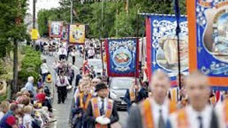 Thousands of people marching at a July 12 Orange Order parade 