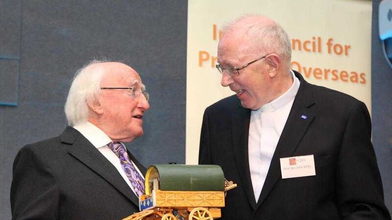 Bishop of Clonfert John Kirby, chairman of the Council for Emigrants of the Irish Bishops&#39; Conference, presents President Michael D. Higgins with a matchstick caravan made by an Irish prisoner in the UK. A conference to mark the 30th anniversary of Irish Council for Prisoners Overseas was held in Dublin Castle on Tuesday 
