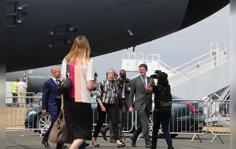 Theresa May and Business Secretary, Greg Clark (right), arrive at the Farnborough International Airshow in Hampshire. Picture by&nbsp;Matt Cardy, Press Association