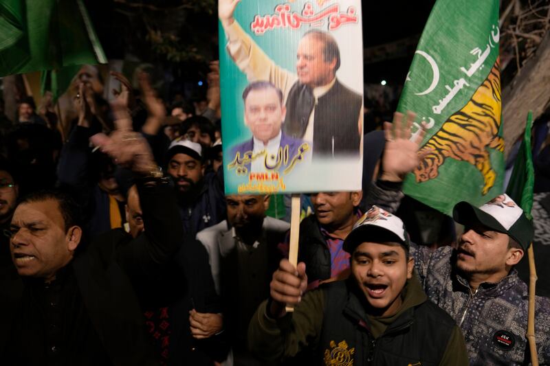 Supporters of Pakistan’s former prime minister Nawaz Sharif’s party chant slogans outside party headquarters in Lahore (KM Chaudary/AP)
