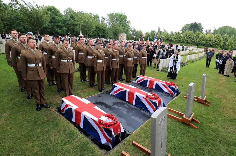 The coffins of two young privates and an unknown soldier, who fought during the first World War, during a burial service at Hermies Hill British Cemetery, near Albert, France