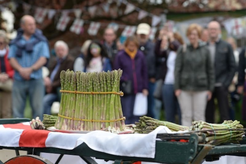 people look at a bunch of asparagus (Joe Giddens/PA)