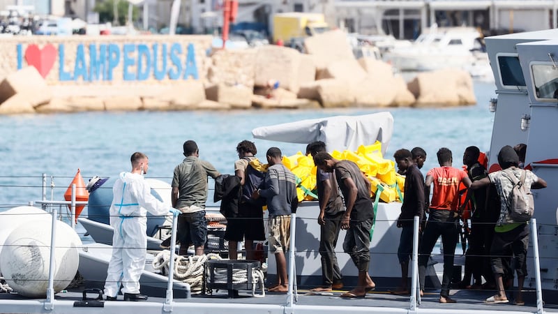 People thought to be migrants stand in a boat of the Italian Finance Police before disembarking at the port of the Sicilian island of Lampedusa, southern Italy, on Monday (Cecilia Fabiano/LaPresse via AP/PA)