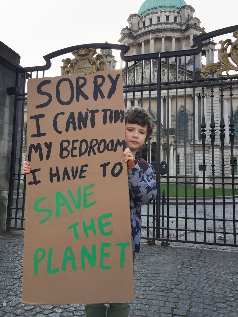 Archie Agnew, aged 8, at a climate change protest outside Belfast City Hall