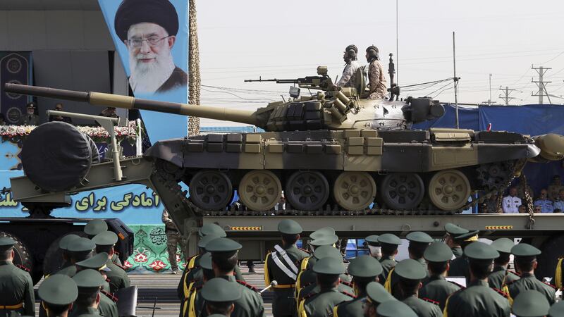 A tank of Iran's paramilitary Revolutionary Guard is driven past a portrait of Supreme Leader Ayatollah Ali Khamenei during a military parade commemorating the anniversary of the start of the 1980-88 Iraq-Iran war, in front of the shrine of the late revolutionary founder Ayatollah Khomeini, just outside Tehran, Iran, Thursday, September 22 2022. (AP Photo/Vahid Salemi)