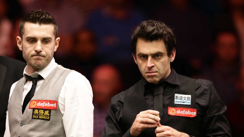 Ronnie O'Sullivan chalks his cue as Mark Selby looks on during the Dafabet Masters at the Alexandra Palace in London on Thursday<br />Picture by PA&nbsp;