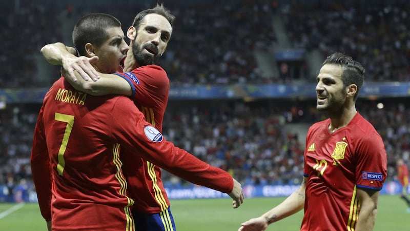 Spain's Alvaro Morata, left, celebrates with his teammates Juanfran and Cesc Fabregas, right, after scoring his side's first goal during the Euro 2016 Group D soccer match between Spain and Turkey&nbsp;