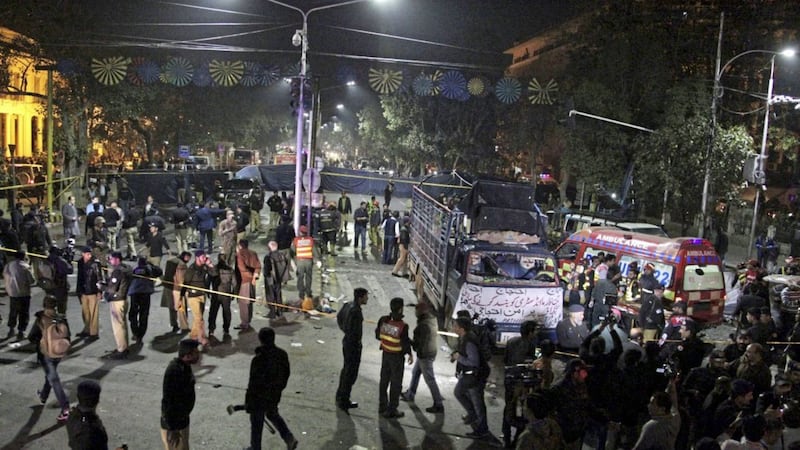 Police and security officers cordon off the area of a deadly bombing, in Lahore, Pakistan. Picture by KM Chaudhry, AP