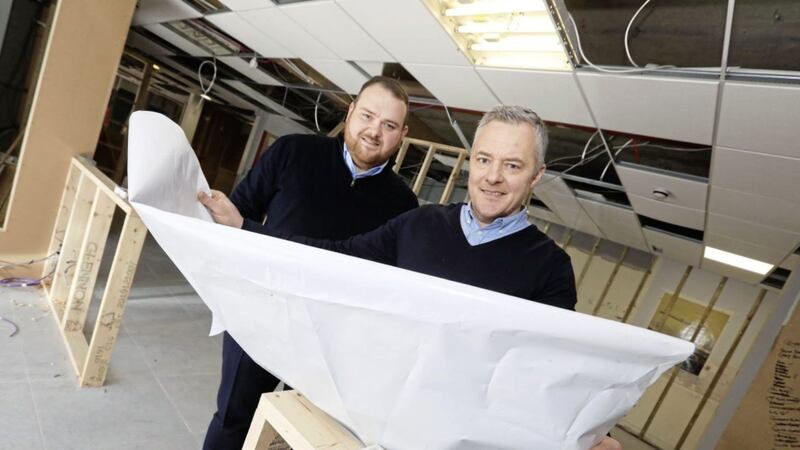 John and Michael Kelly survey plans for the new Homefit store 