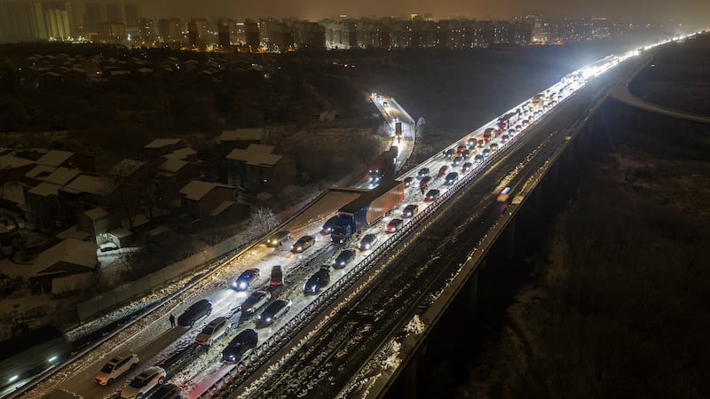 Vehicles were stranded on snow-covered roads in central China (Chinatopix via AP)