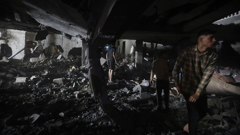 Palestinians search for survivors after an Israeli air strike on a residential building in Rafah refugee camp, southern Gaza Strip (Ismael Abu Dayyah/AP)