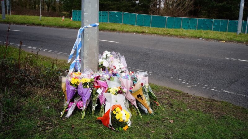 Floral tributes left near the scene in the St Mellons area of Cardiff where three people died in a road traffic accident. A man has been charged with driving offences as part of the police inquiry (PA Wire)