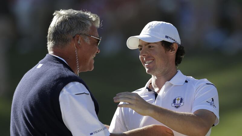 Darren Clarke congratulates Europe's Rory McIlroy after winning his singles match against USA's Keegan Bradley at the Ryder Cup PGA golf tournament on Sunday September 30 2012 at the Medinah Country Club in Medinah, Illinois
