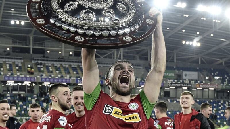 Cliftonville&#39;s Jamie Harney celebrates winning the Co Antrim Shield last month 