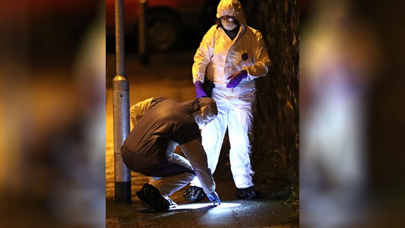 &nbsp;Forensic officers examine the scene of the shooting
