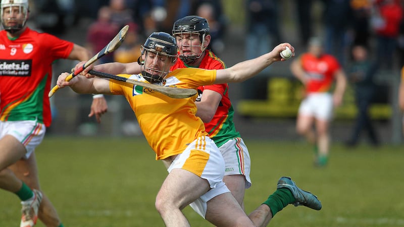 Antrim's Ciaran Clarke is put under pressure by Carlow's Diarmuid Byrne during Sunday's NHL game at Ballycastle <br />Picture by Seamus Loughran&nbsp;
