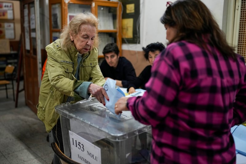A woman casts her ballot in local elections at a polling station in Istanbul (Emrah Gurel/AP)