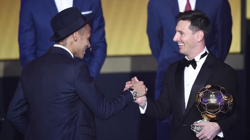 Lionel Messi, right, is congratulated by Barcelona team-mate Neymar after winning the FIFA Men's soccer player of the year 2015 prize