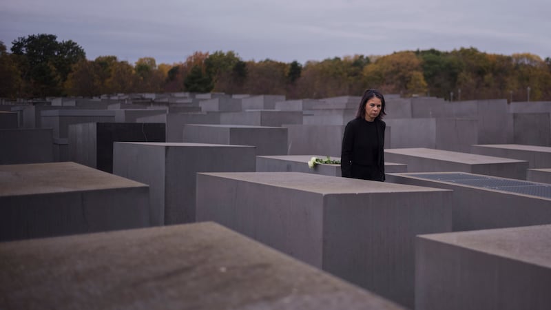 German foreign minister Annalena Baerbock places flowers at The Memorial to the Murdered Jews of Europe, known as Holocaust Memorial, in Berlin to commemorate on the 85th anniversary of the November 1938 progroms in Germany and Austria (Markus Schreiber/AP)