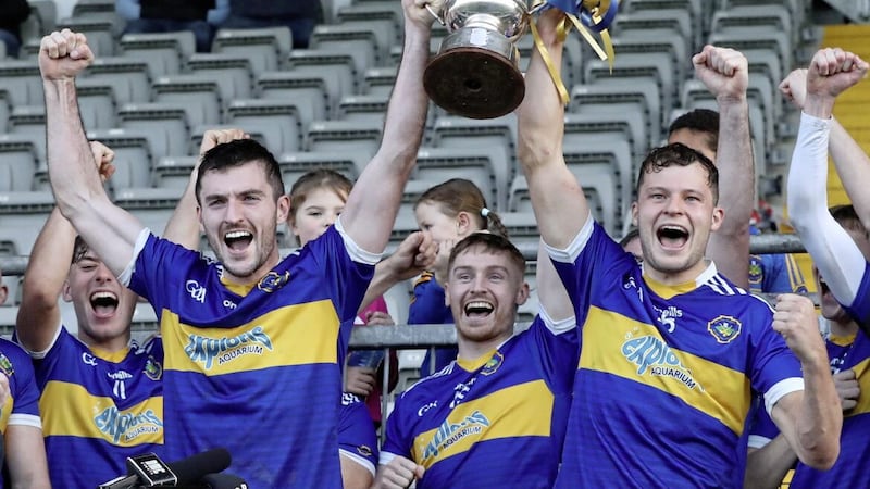 Portaferry&#39;s Matthew Conlan and Daithi Sands lift the cup at P&aacute;irc Esler Picture: Philip Walsh 