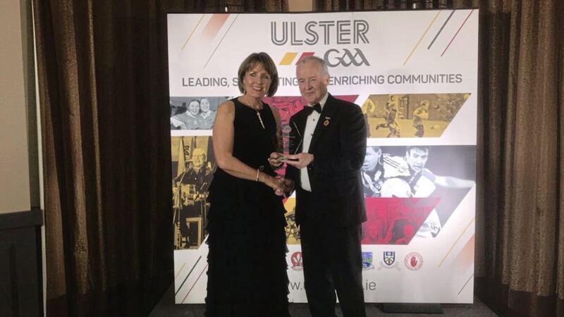 Cumann Pheadair Naofa secretary Anne McCormack receives the Ulster President&rsquo;s Club Maith Club of the Year award from Ulster Council president Michael Hasson at the City Hotel in Derry last Friday 