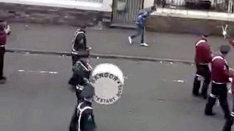 A man seen on video throwing a bin at a loyalist band in south Belfast 