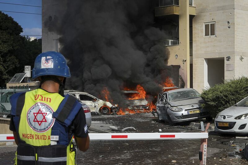 Vehicles burn after a rocket fired from the Gaza Strip hit a car park in Ashkelon, southern Israel (Tsafrir Abayov/AP/PA)
