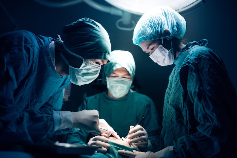 Surgical team working on a patient in operating theatre