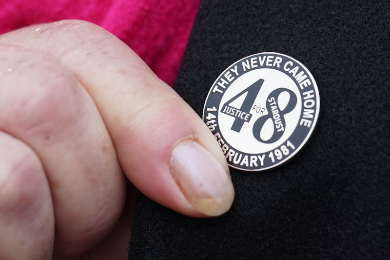 A family member touches her Stardust lapel pin on her way into Dublin Coroner’s Court in March