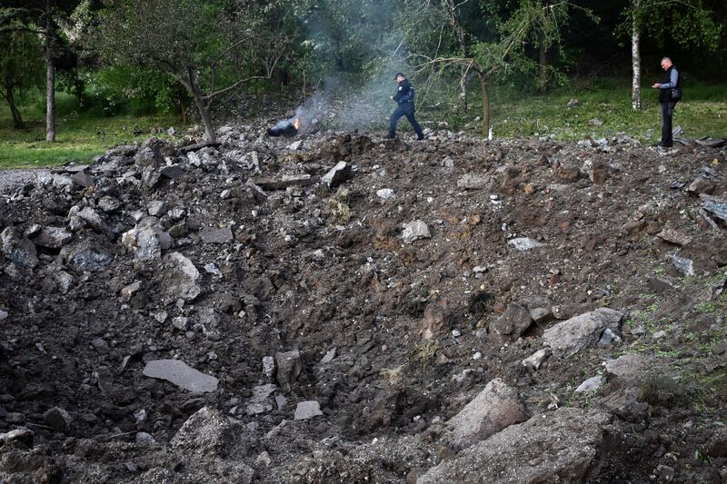 Police officers inspect a crater after a Russian missile attack in Zaporizhzhia, Ukraine (Andriy Andriyenko/AP)