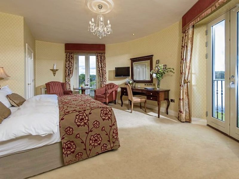 Interior of one of the plush bedrooms in a loughside lodge at Lough Erne Resort 