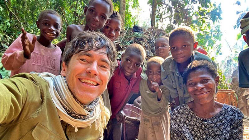 Simon Reeve with a remote Baka community in the Congo